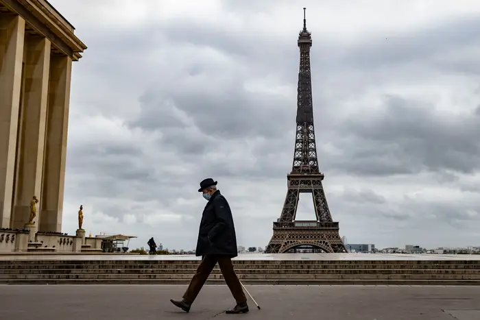 A man walks across a deserted Trocadero square near the Eiffel Tower, on the first morning of the second national lockdown in France.
